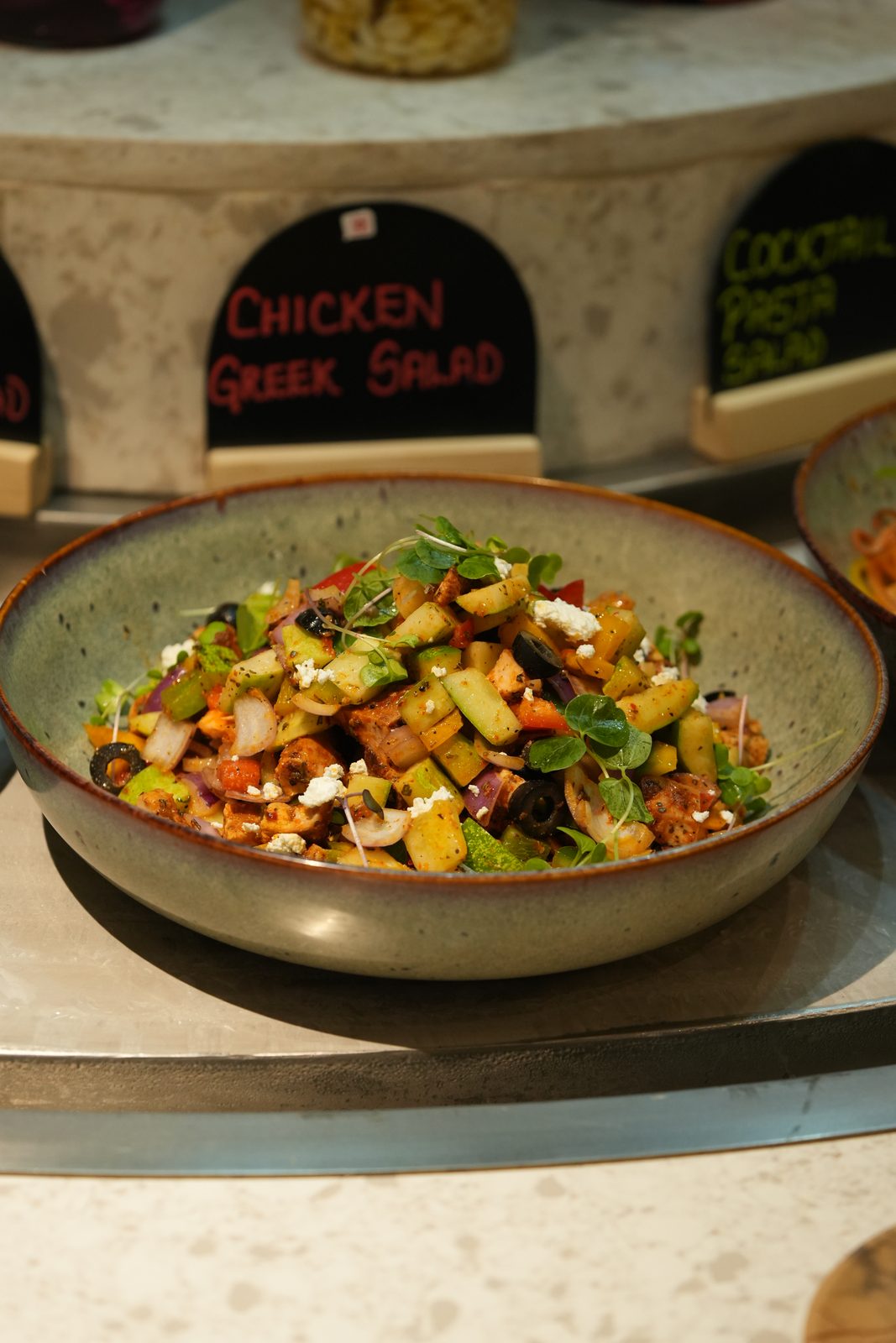 A bowl of Greek chicken salad at the salad station